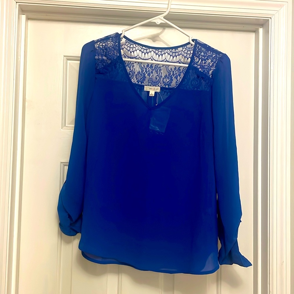 Woman’s blouse new with tags. Never worn.